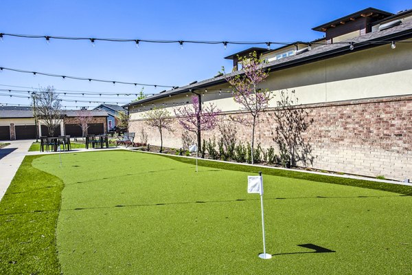 Golf putting practice area with lush greenery at McKinney Terrace Apartments Perfect for golf enthusiasts seeking leisure and recreation