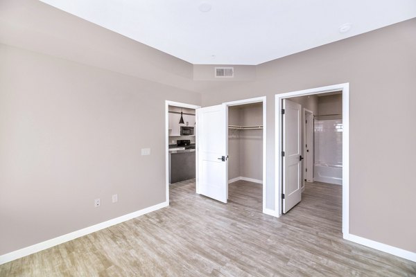 Cozy bedroom with stylish decor at The Premiere at Eastmark Apartments