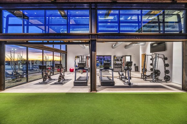 State-of-the-art fitness center at The Premiere at Eastmark Apartments featuring modern exercise equipment