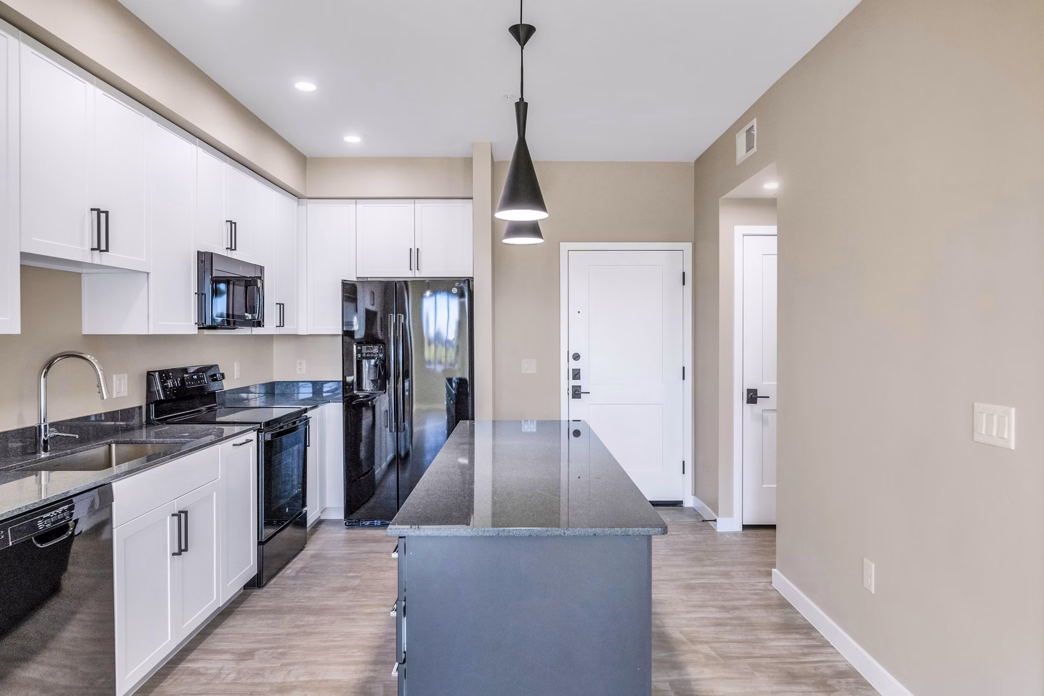 Modern kitchen with stainless steel appliances at The Premiere at Eastmark Apartments