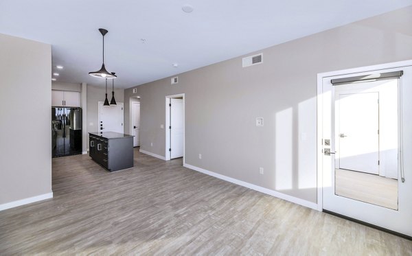 Spacious living room with modern furnishings in The Premiere at Eastmark Apartments