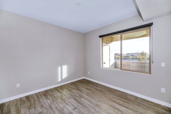 Stylish living room with modern furnishings at The Premiere at Eastmark Apartments, featuring bright natural light and contemporary design