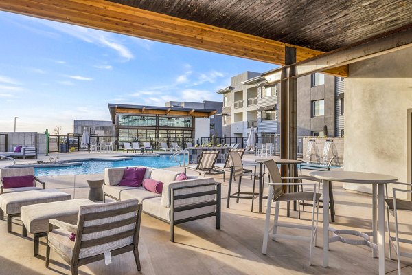 The Premiere at Eastmark: Stylish patio space at luxury apartments, ideal for outdoor relaxation and gatherings in a Greystar community