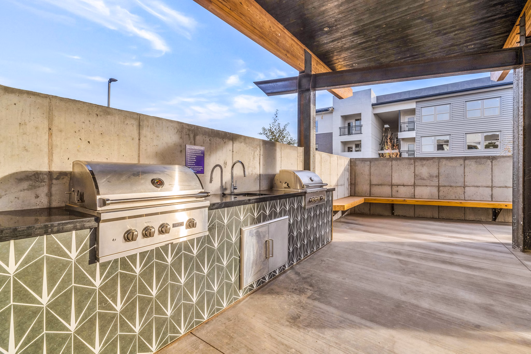 Outdoor grill and patio area at The Premiere at Eastmark Apartments, ideal for social gatherings and relaxation