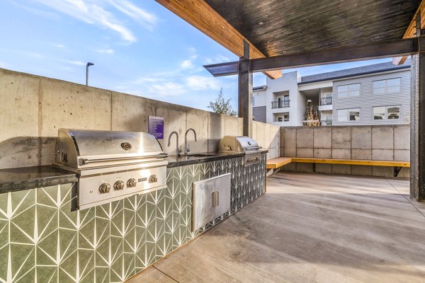 Outdoor grill and patio area at The Premiere at Eastmark Apartments, ideal for social gatherings and relaxation