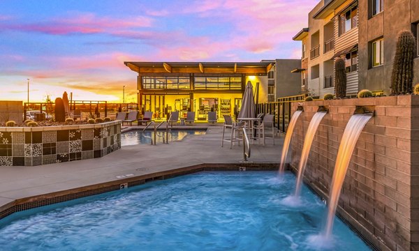 Relax by the resort-style pool at The Premiere at Eastmark Apartments, a luxury community offering premium amenities in a serene setting