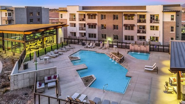 The Premiere at Eastmark: Resort-style pool with sundeck at luxury apartments, perfect for relaxation