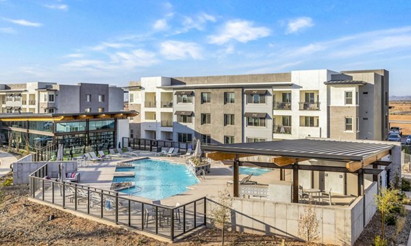 Relaxing poolside retreat at The Premiere at Eastmark Apartments with luxury seating and scenic views