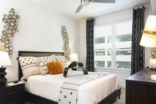 Cozy bedroom featuring a queen bed and modern decor at Parkside at Round Rock Apartments