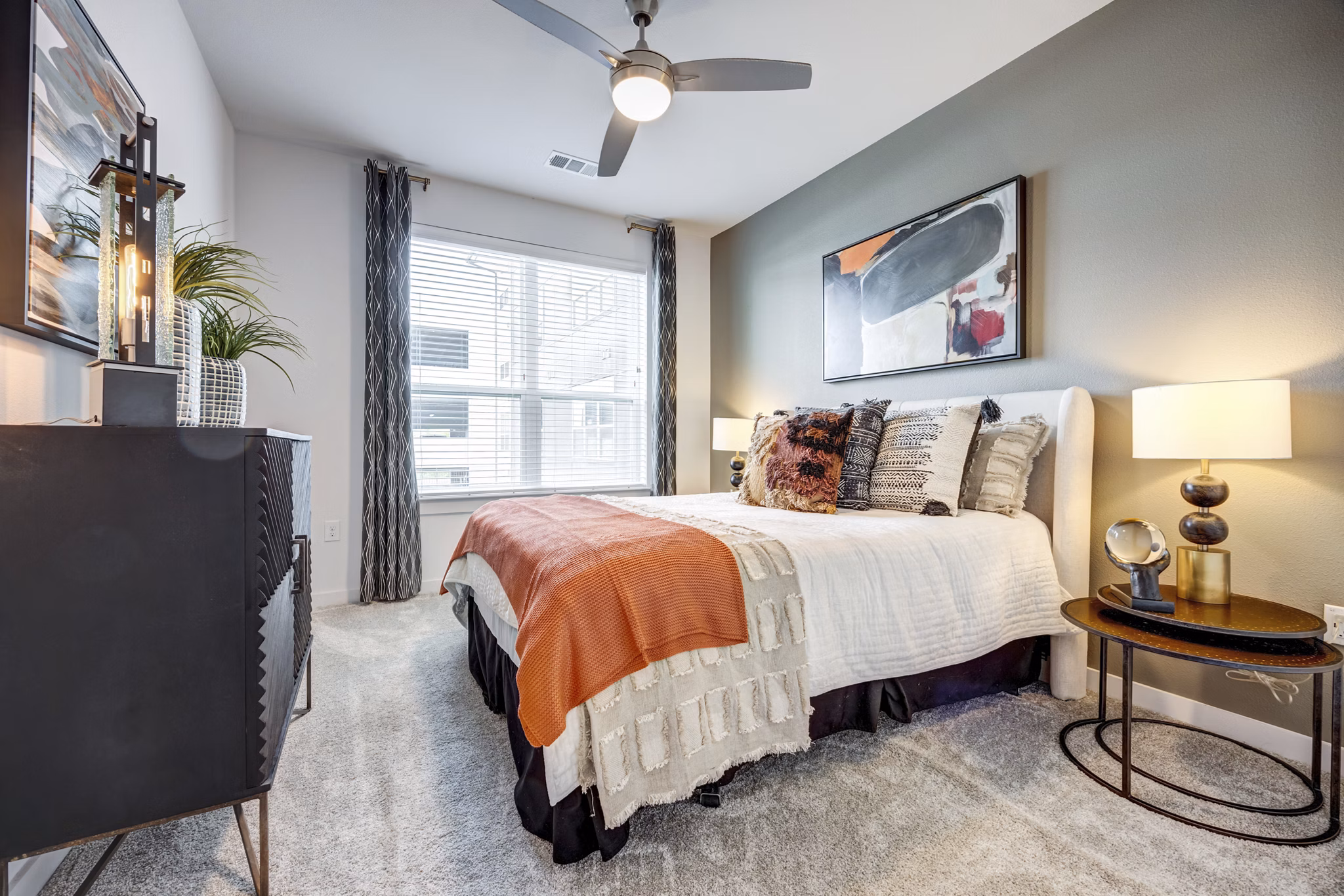 Bedroom featuring modern decor and large window at Parkside at Round Rock Apartments