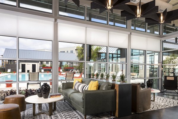 Modern clubhouse featuring a spacious lounge and game areas at Parkside at Round Rock Apartments