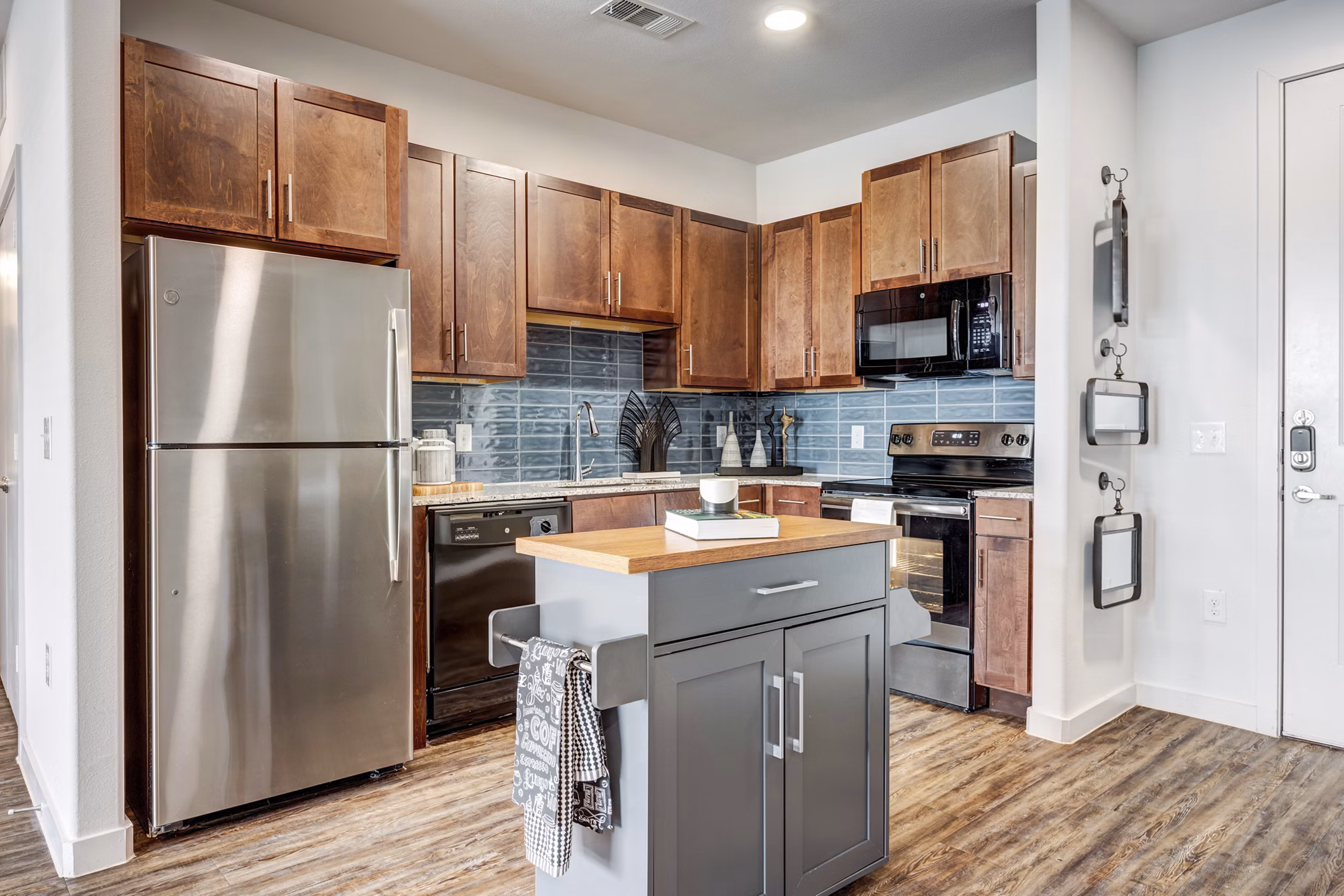 Modern kitchen with stainless steel appliances in Parkside at Round Rock Apartments