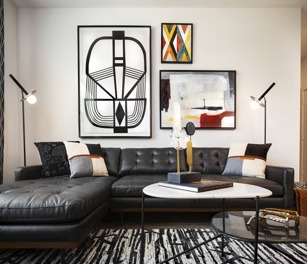 Living room featuring modern decor and large windows at Parkside at Round Rock Apartments