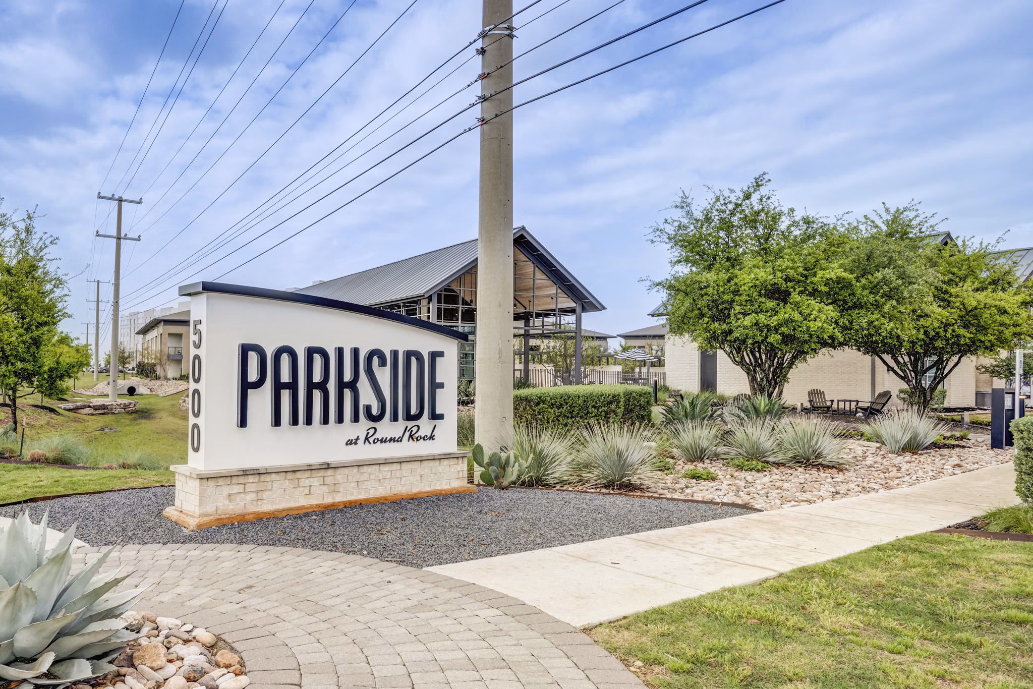 Welcome signage at Parkside at Round Rock Apartments featuring luxury living amenities