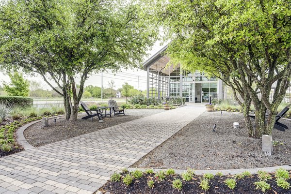 Playground area with climbing equipment at Parkside at Round Rock Apartments, offering family-friendly outdoor recreation features