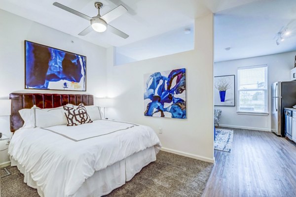 Bedroom with modern furnishings and natural light at Vineyard Apartments luxury community