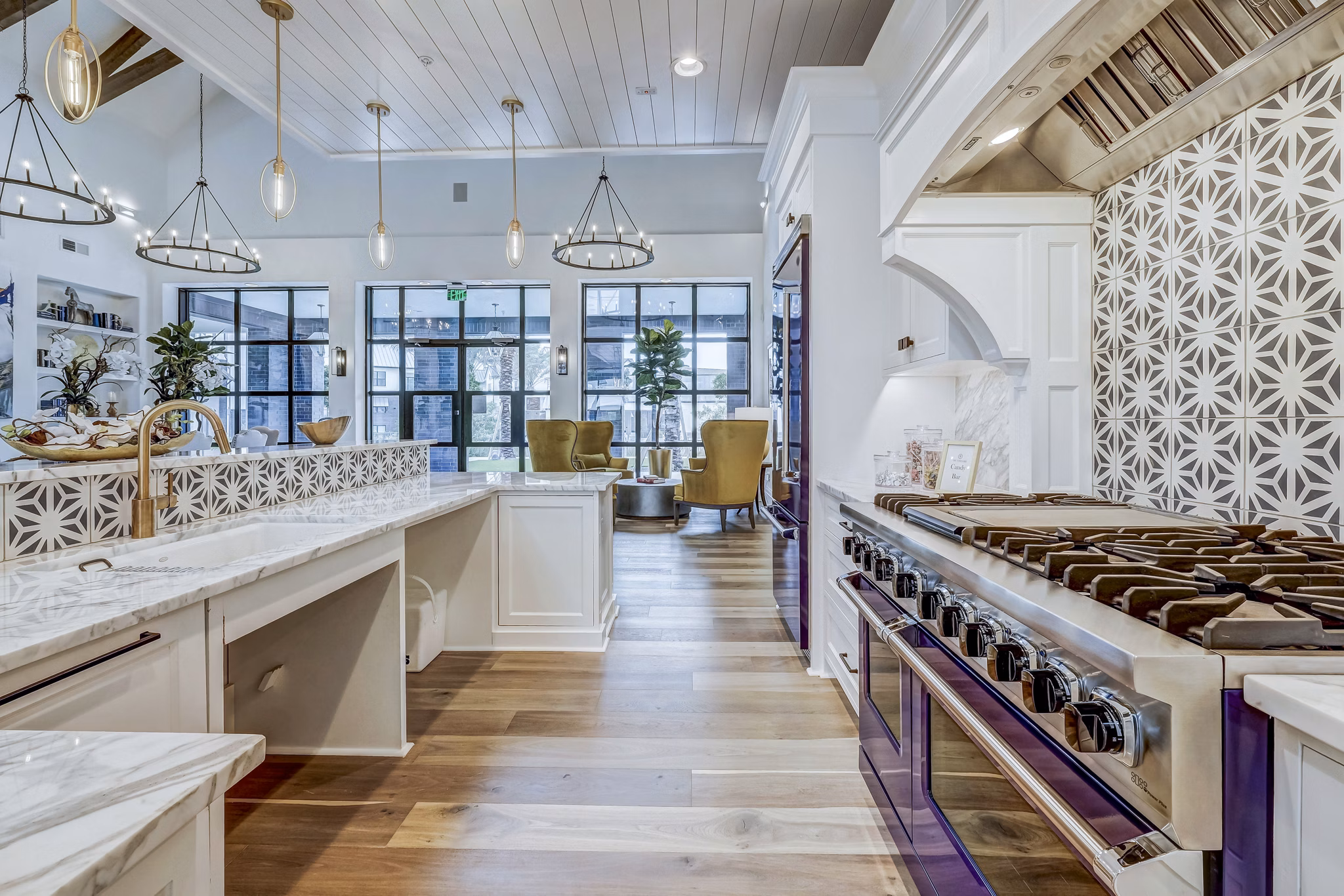 Clubhouse kitchen featuring modern appliances and island seating at Vineyard Apartments