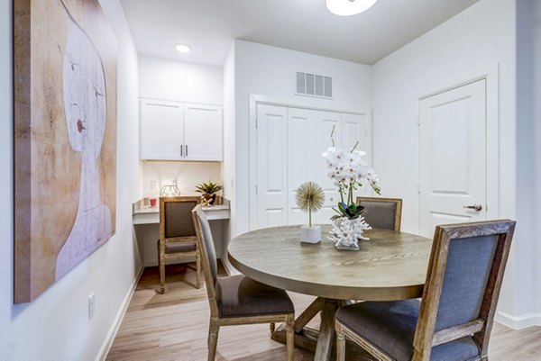 Dining room with elegant lighting and modern furnishings in Vineyard Apartments, luxurious spaces for fine dining experiences