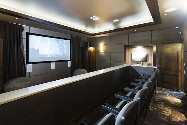 The Trails at Timberline: Theater room with plush seating and large screen for luxury apartment residents