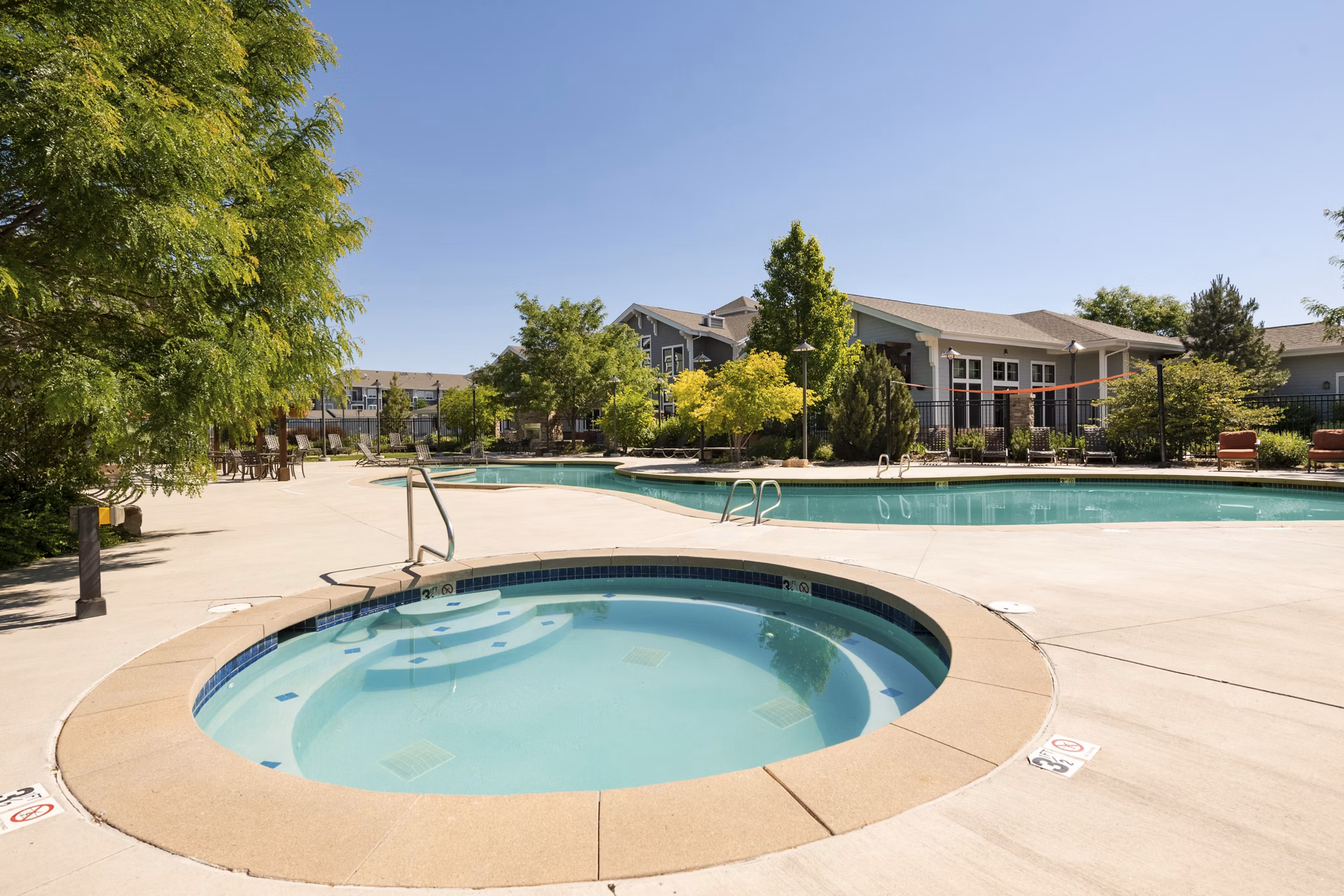 Relaxing hot tub at The Trails at Timberline Apartments, offering a serene retreat in a luxury setting