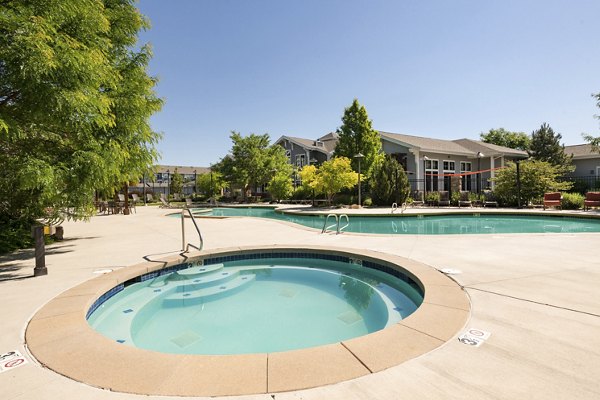 Relaxing hot tub at The Trails at Timberline Apartments, offering a serene retreat in a luxury setting