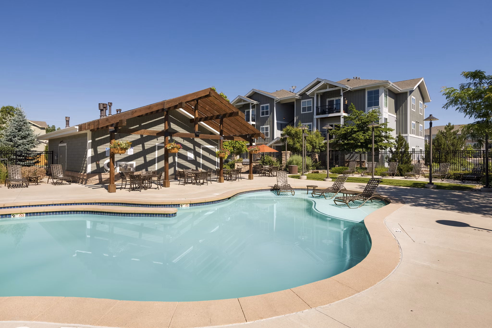 Resort-style pool with sundeck at The Trails at Timberline Apartments, offering luxury living in Fort Collins