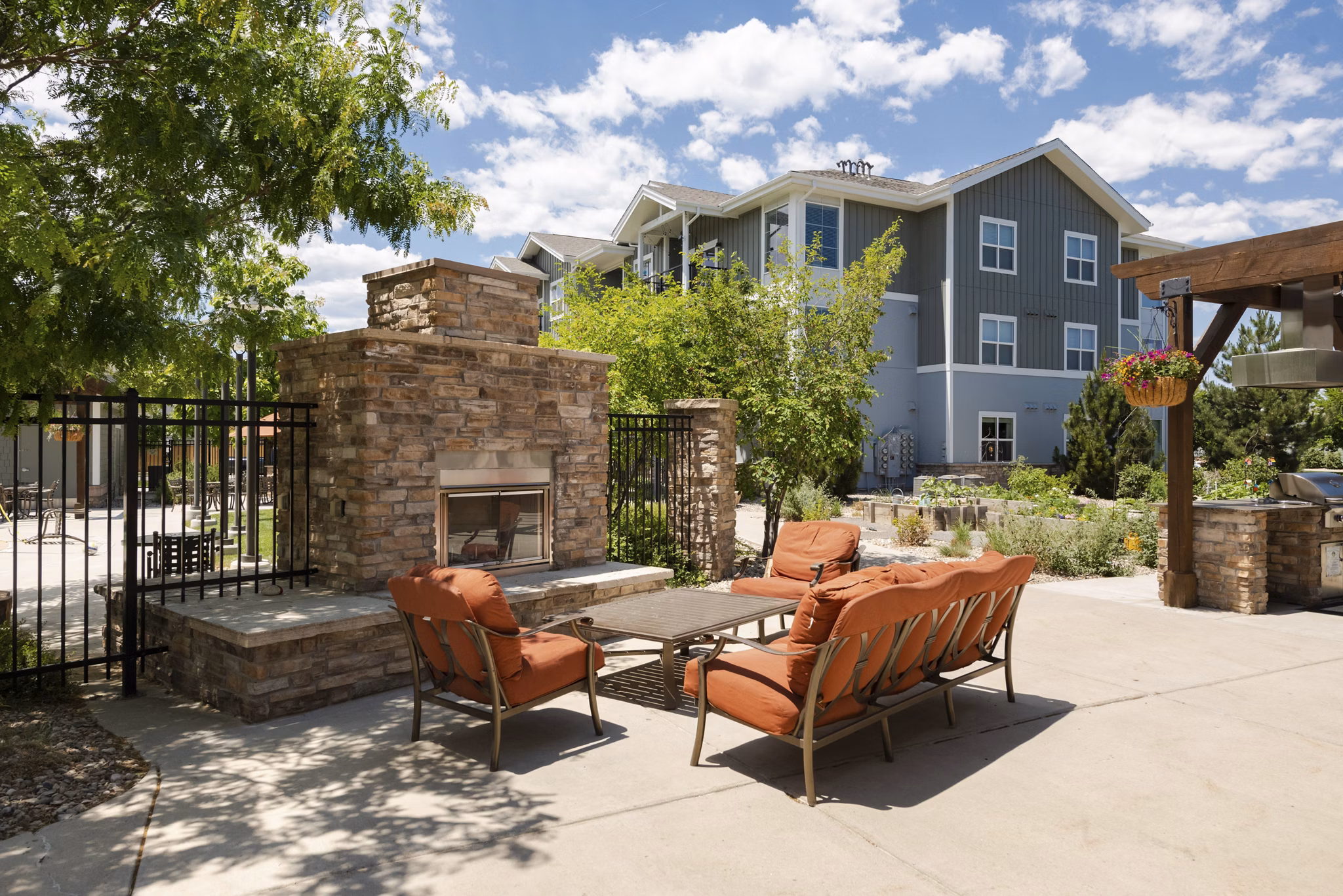 Outdoor fire pit with cozy seating at The Trails at Timberline Apartments offering luxury living experience