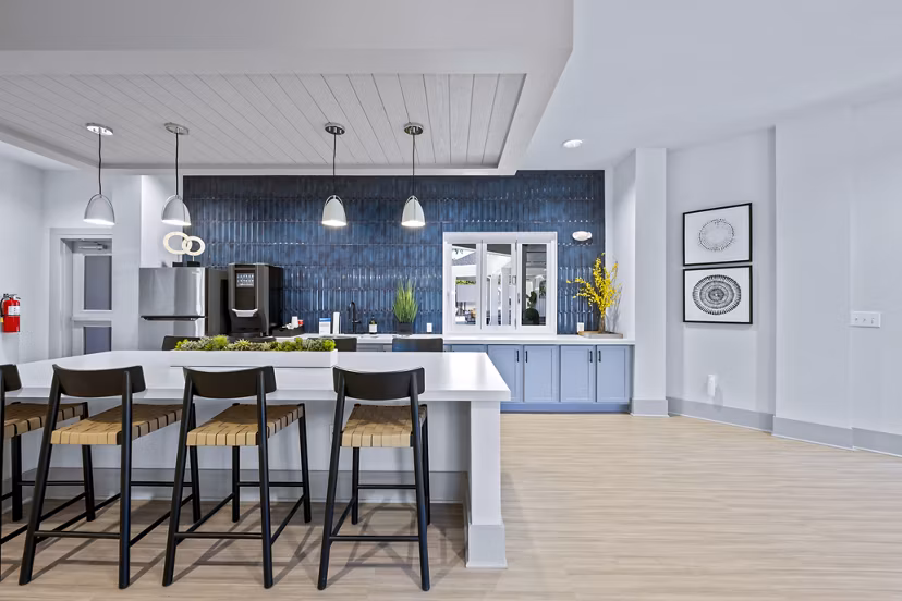 Clubhouse featuring modern design and ample seating at Wayford at Innovation Park Apartments, ideal for community gatherings and events