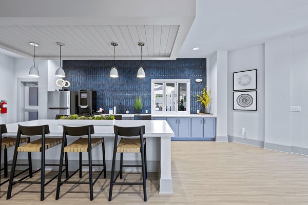 Clubhouse featuring modern design and ample seating at Wayford at Innovation Park Apartments, ideal for community gatherings and events
