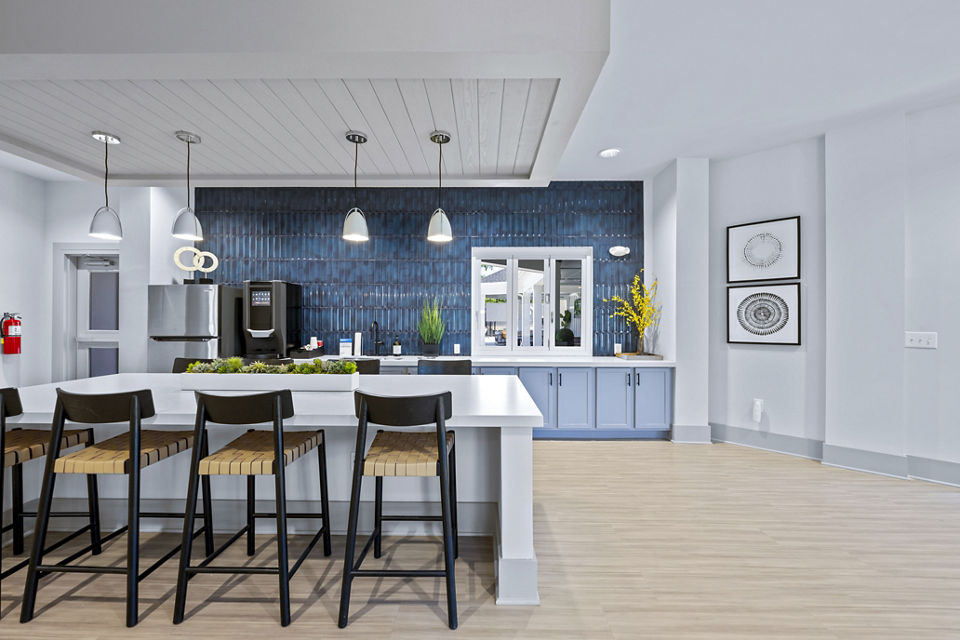 Clubhouse featuring modern design and ample seating at Wayford at Innovation Park Apartments, ideal for community gatherings and events