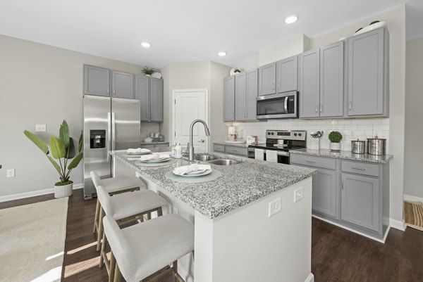 Modern kitchen with stainless steel appliances at Wayford at Innovation Park Apartments