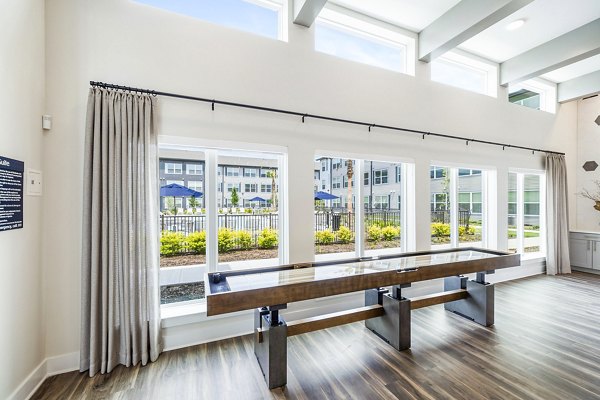 Clubhouse game room with billiards and lounge seating at Ltd Med Center Apartments