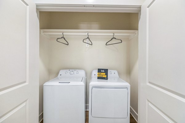 Laundry room featuring modern appliances in Ltd Med Center Apartments, a luxurious Greystar property