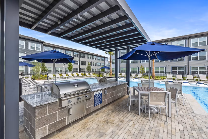 Outdoor grill area and patio at Ltd Med Center Apartments