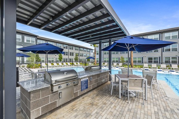 Outdoor grill area and patio at Ltd Med Center Apartments