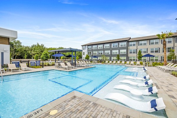 Sunlit pool area at Ltd Med Center Apartments offering luxury amenities for relaxation