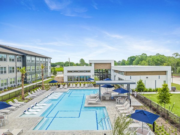 Resort-style pool at Ltd Med Center Apartments with lounging areas and lush landscaping