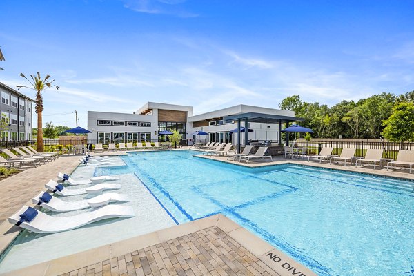 Luxurious pool at Ltd Med Center Apartments with resort-style seating and lush landscaping