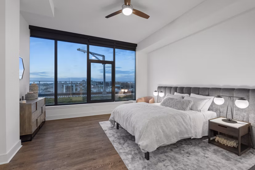 Cozy bedroom with modern decor at Stanza Little Italy Apartments