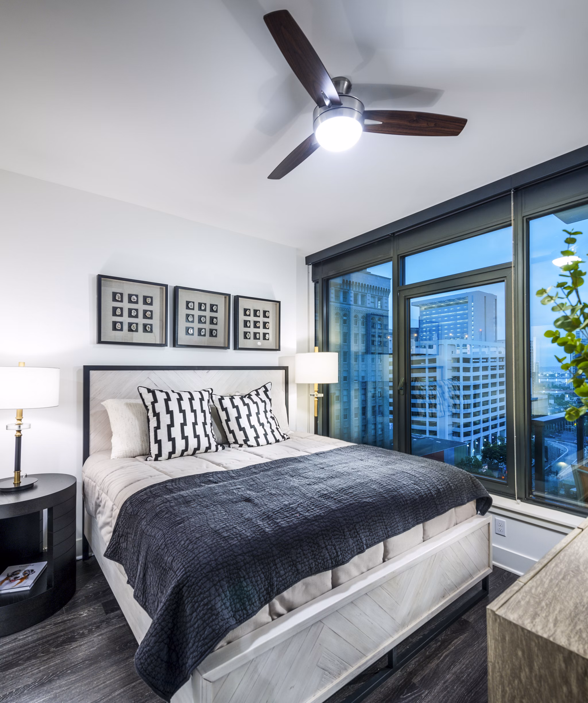 Cozy bedroom with modern decor at Stanza Little Italy Apartments