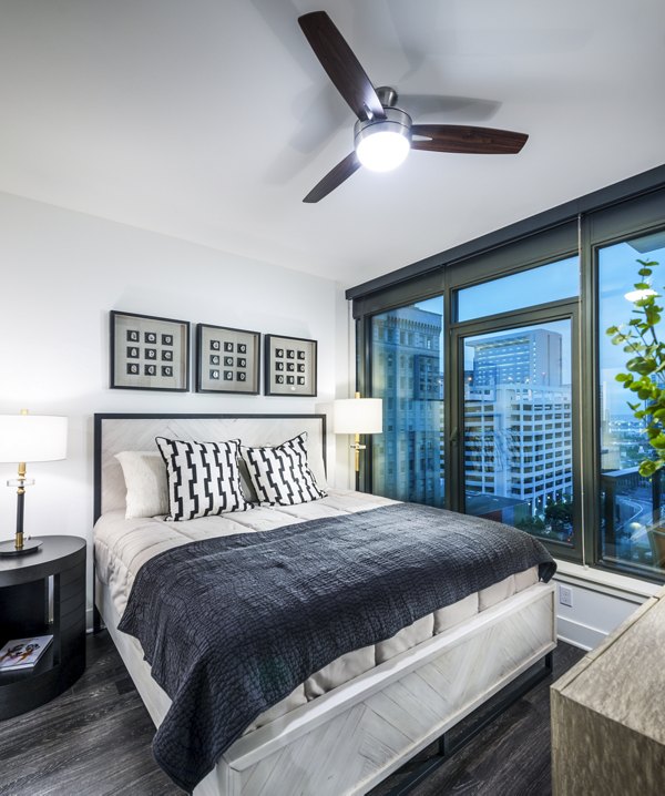 Cozy bedroom with modern decor at Stanza Little Italy Apartments