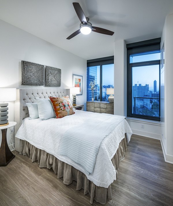 Cozy bedroom with elegant design at Stanza Little Italy Apartments featuring Greystar luxury