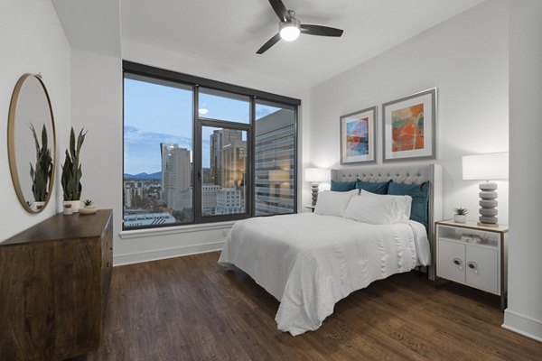 Stylish bedroom with modern decor and plush bedding at Stanza Little Italy Apartments