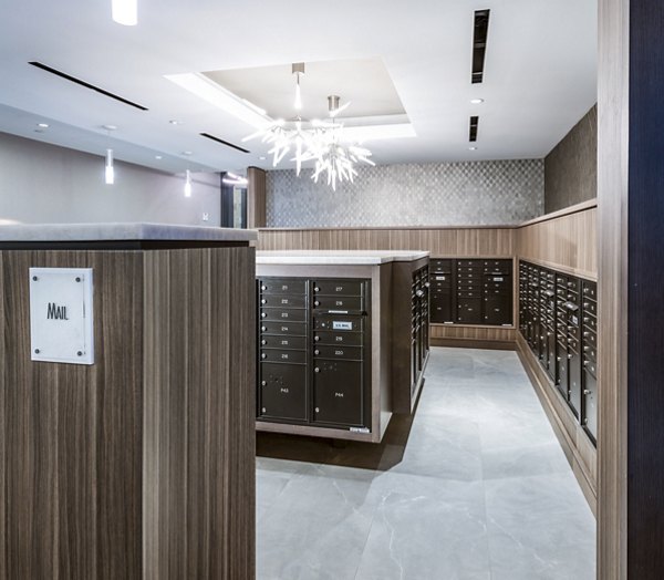 Mail room with secure package lockers at Stanza Little Italy Apartments