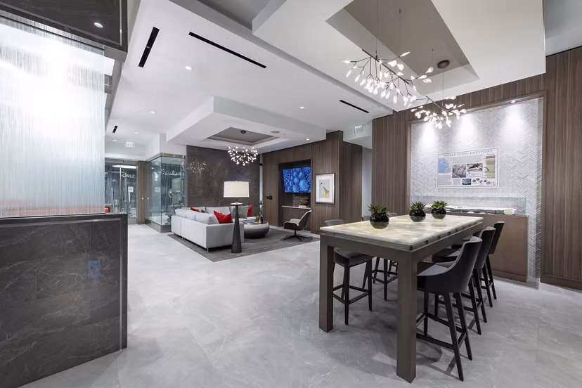 Clubhouse kitchen featuring modern appliances and spacious seating at Stanza Little Italy Apartments