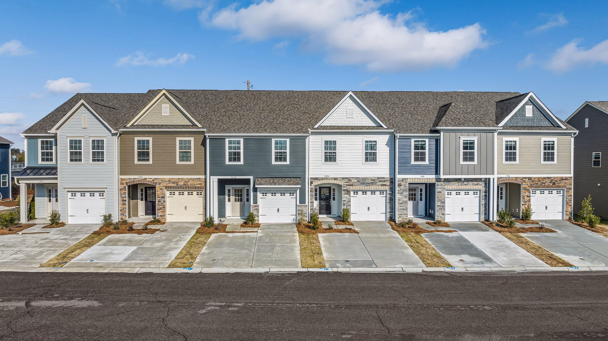 ABODE at Parkside: Charming townhome-style apartments with classic architecture in a lush, park-like setting