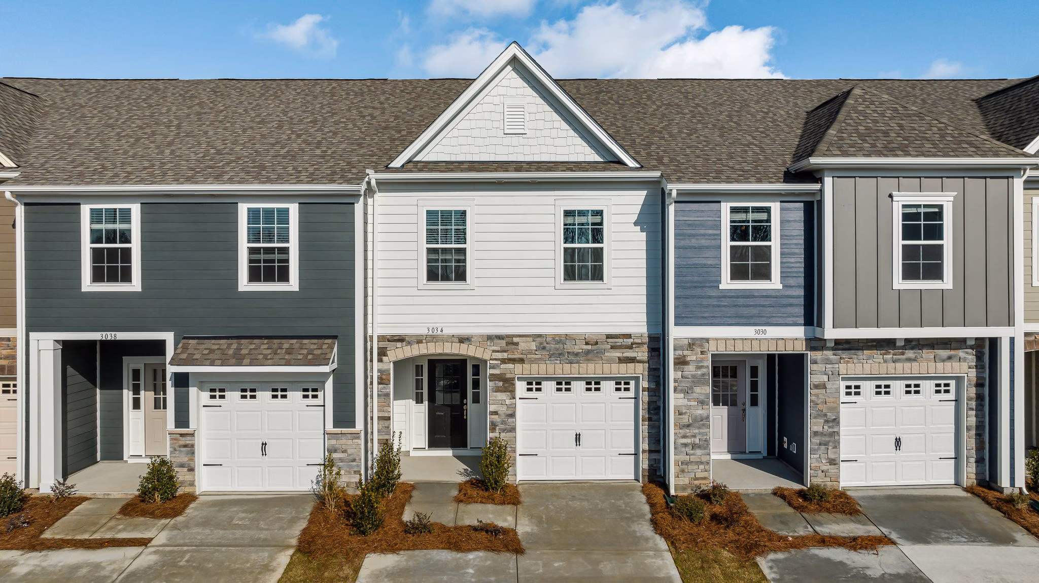 ABODE at Parkside: Modern townhome community with lush landscaping