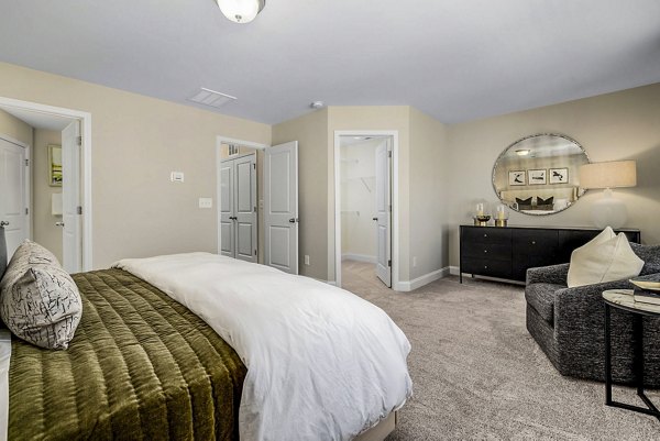 Cozy bedroom with modern decor at ABODE at Parkside Apartment Townhomes, offering luxury accommodation in urban setting