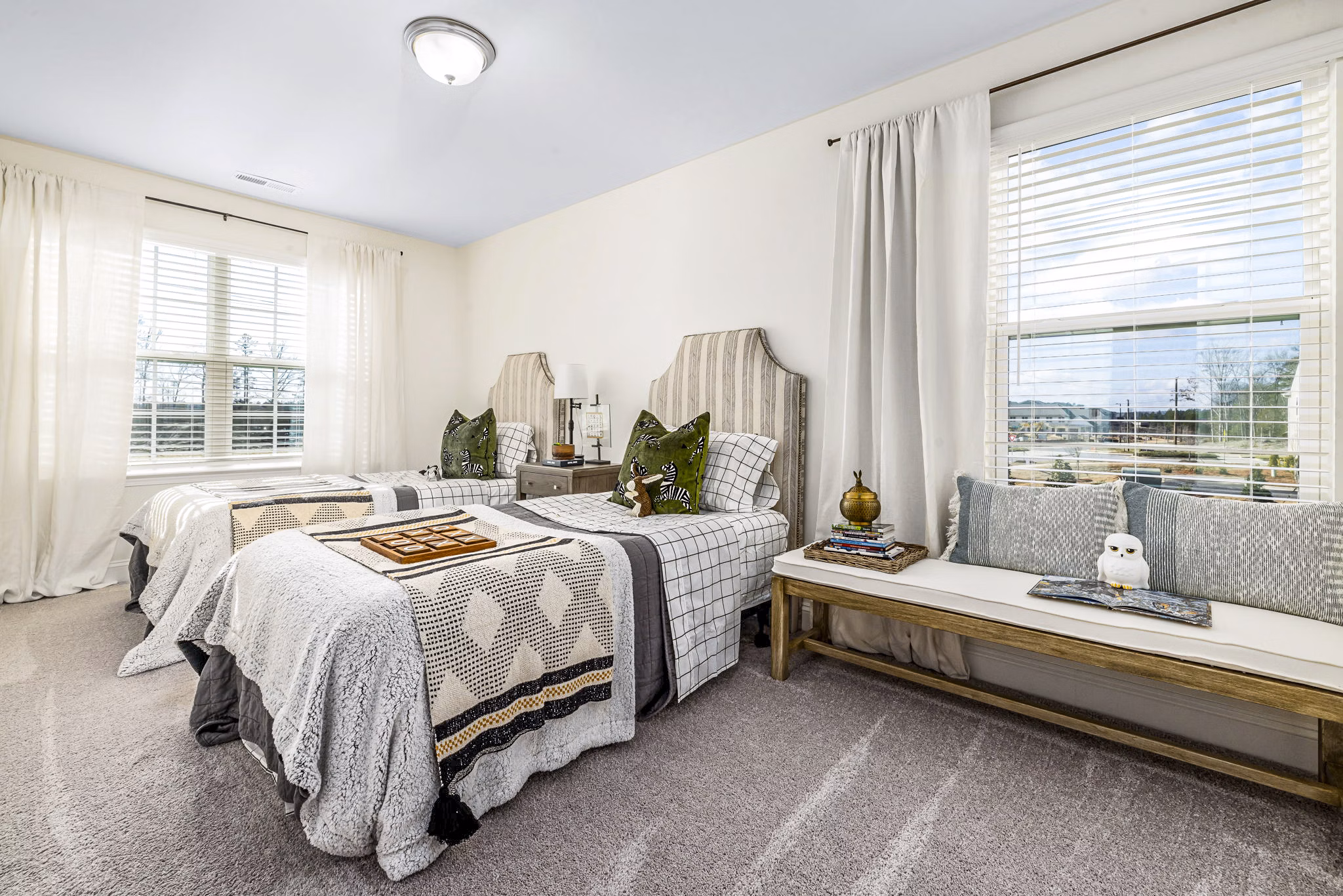 Bedroom with modern decor and ample natural light at ABODE at Parkside Apartment Townhomes
