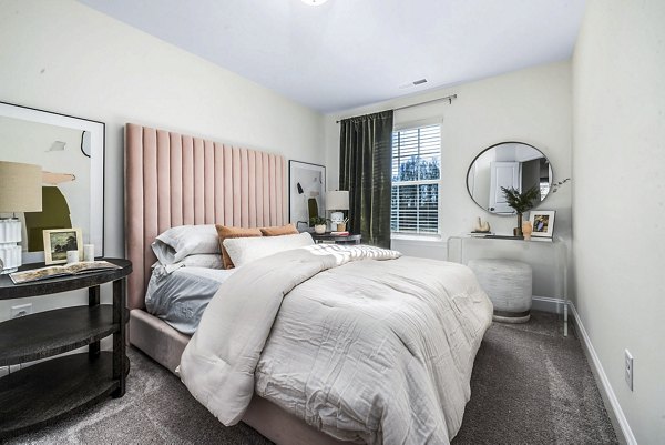 Cozy bedroom with modern decor at ABODE at Parkside Apartment Townhomes, offering luxury living in a tranquil setting